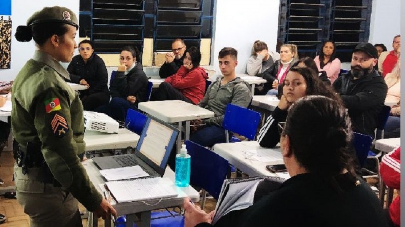 sala de aula, alunos e uma militar falando